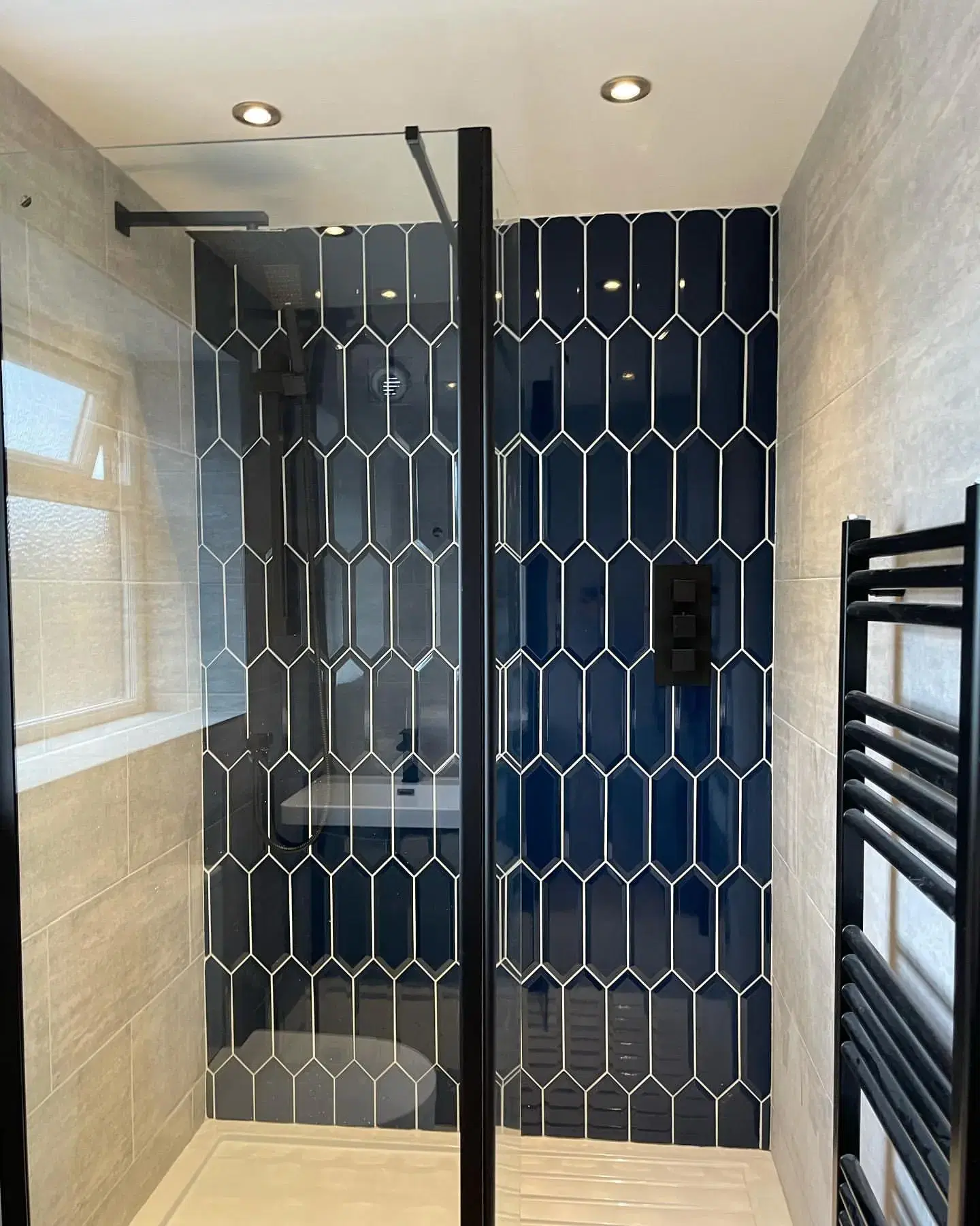 A modern shower with glass enclosure